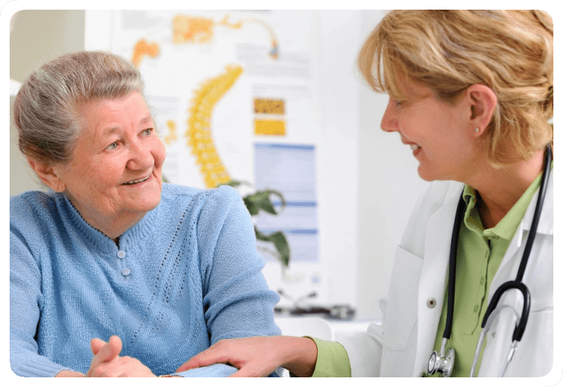 A woman talking to a doctor in an office.