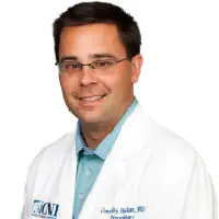 A man in white lab coat and glasses.