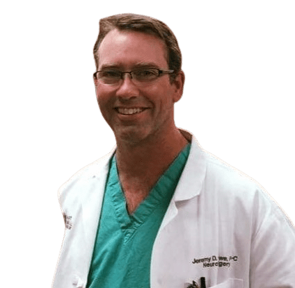 A male doctor wearing glasses and a white lab coat.